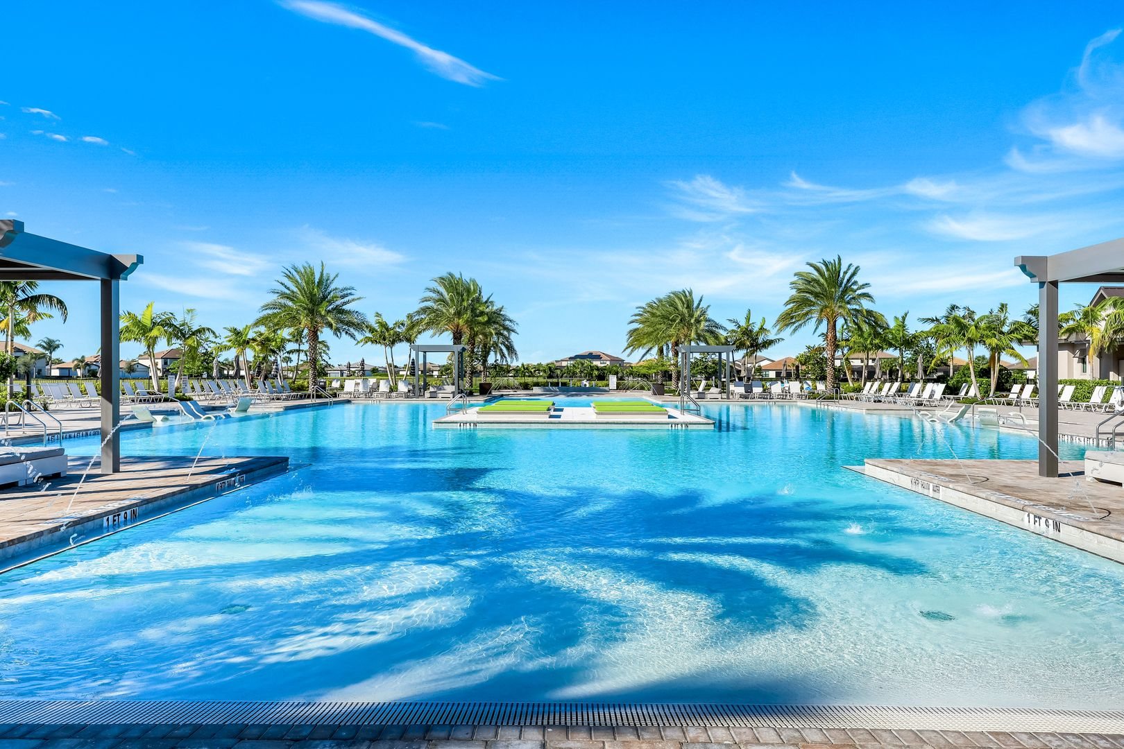 Resort style pool with palms and cabanas at Verdana Village in Estero, Florida